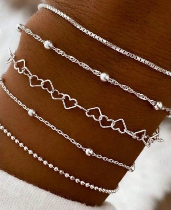 A golden six - piece set Chic Multi - Layered Alloy Bracelet Set - Fashionable Stackable Jewelry - RnR Galore